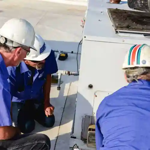 Men working on business's hvac unit