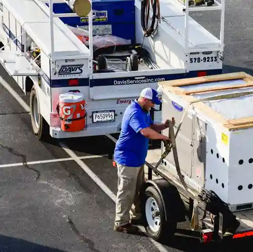 Man transporting commercial hvac unit